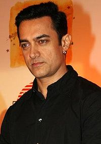 An Indian man wearing a black dress shirt.
