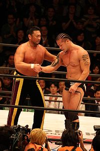 Toshiaki Kawada and Zeus shaking hands.jpg